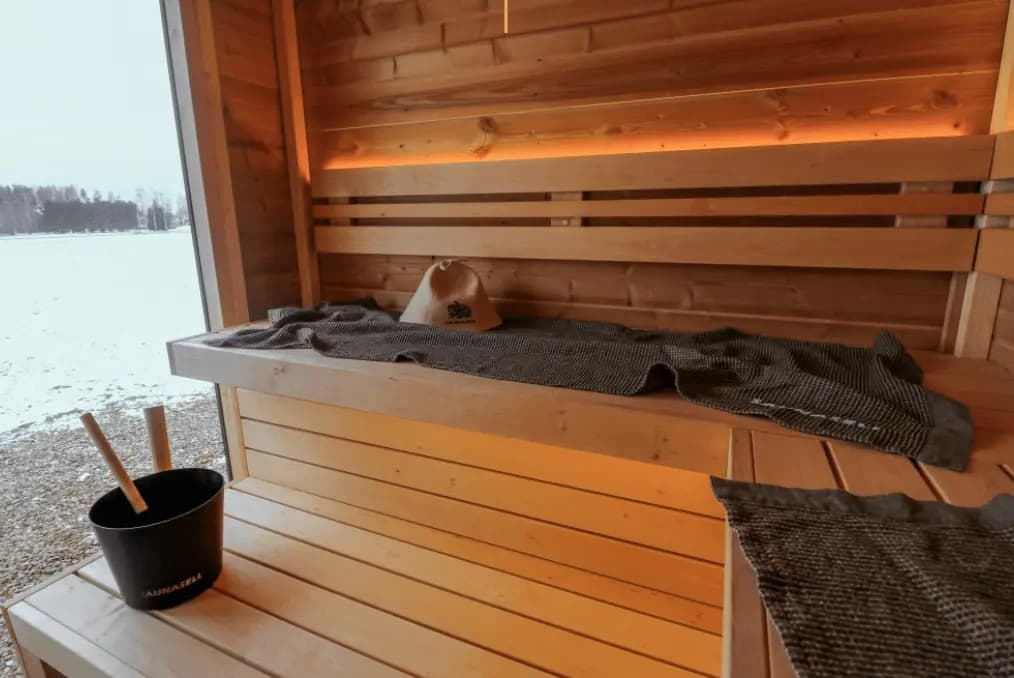 Sauna bench looking out over water through a wide window